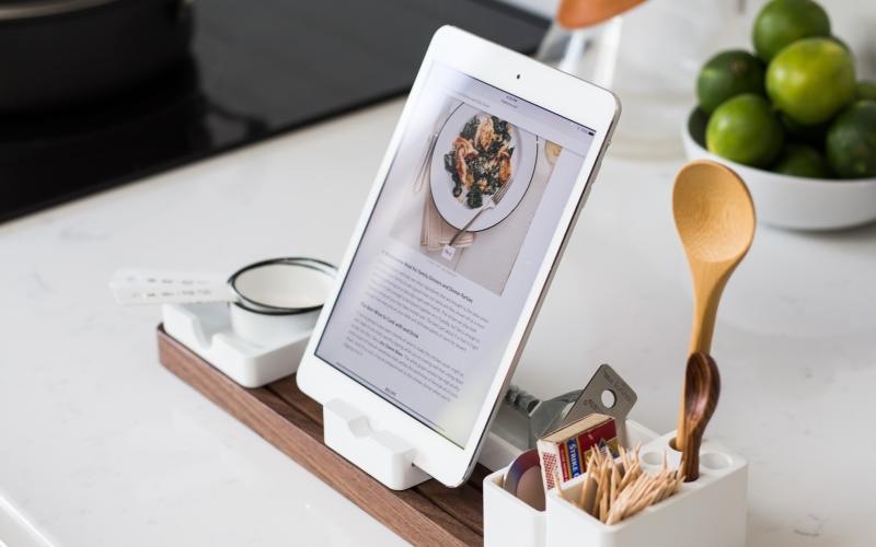 a table with a tablet and a spoon on it
